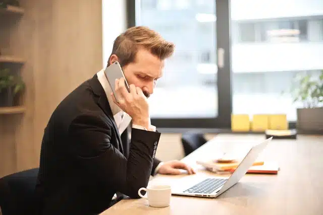 man on phone at desk