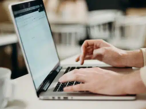 hands typing on a laptop