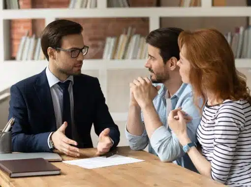 three people sitting at a desk