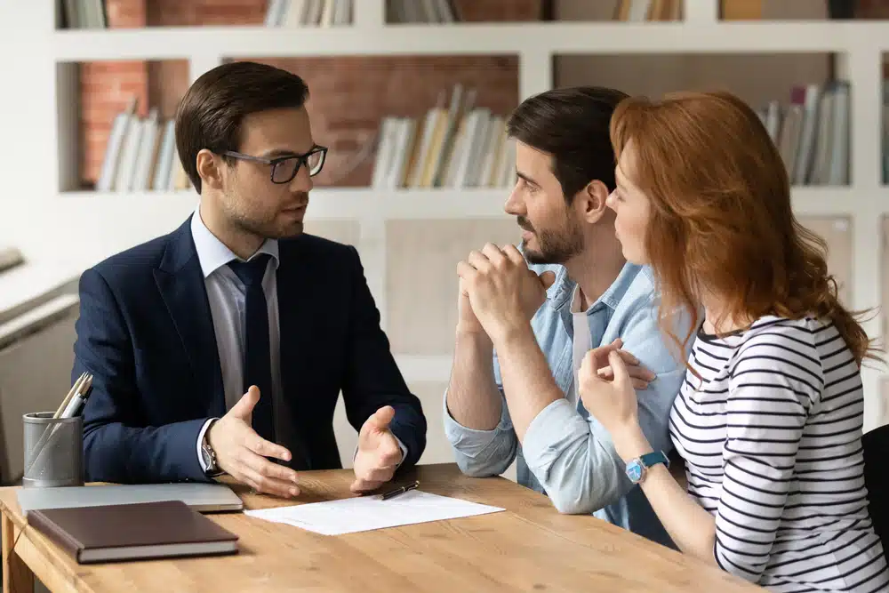 three people sitting at a desk