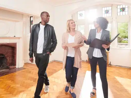 realtor standing in room with buyers