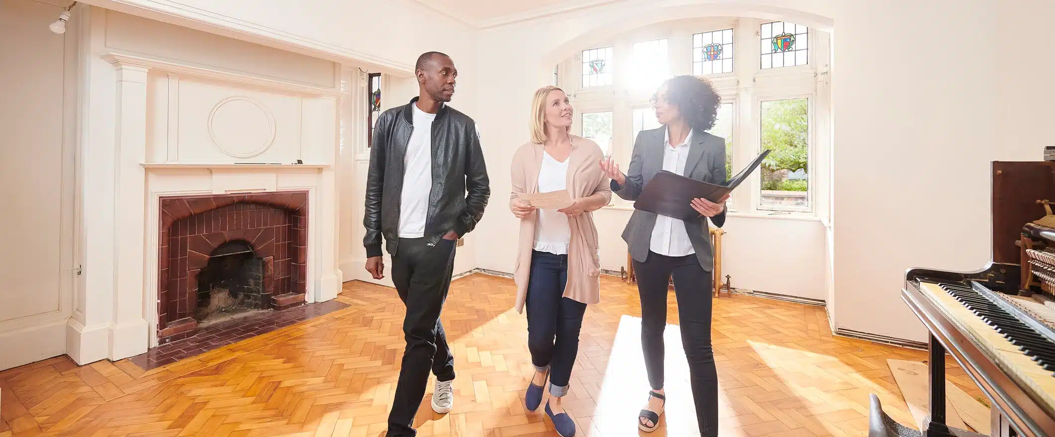 realtor standing in room with buyers