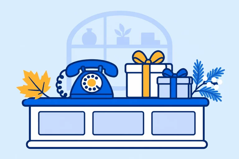 A small business counter with a blue phone, gift boxes, an autumn leaf, and a winter branch.