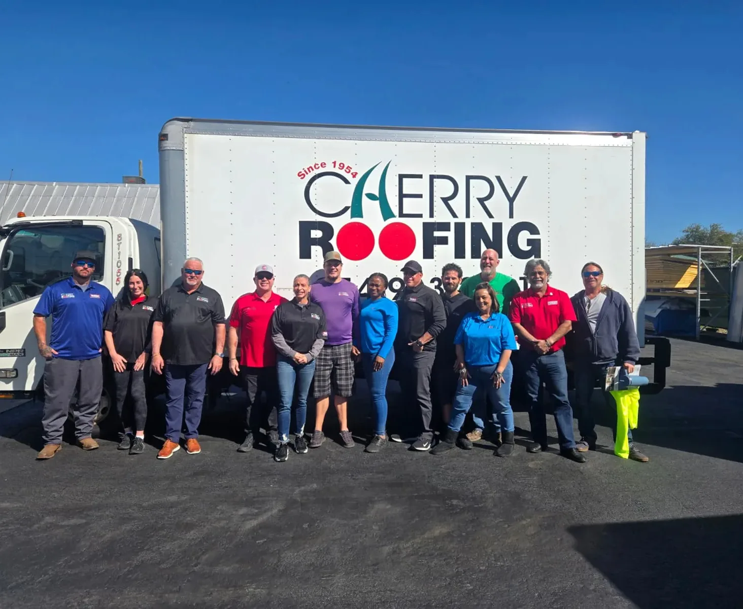 Cherry Roofing team in front of a branded company truck